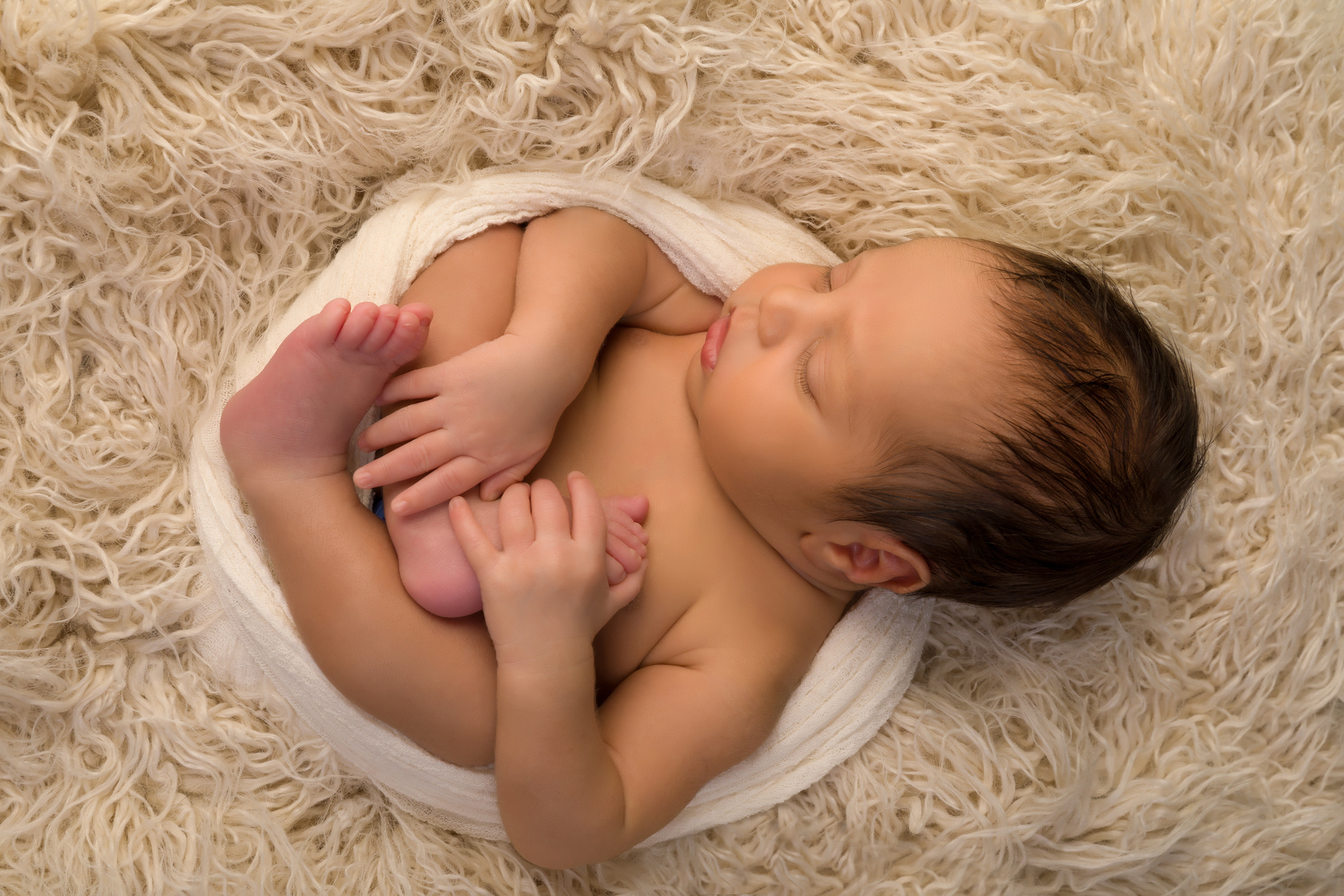 Newborn Baby Holding His Toes